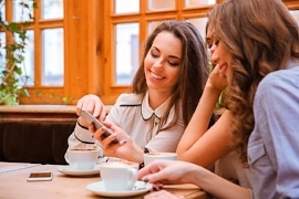 Portrait of a smiling three women using smartphone in cafe together-295573-edited.jpeg